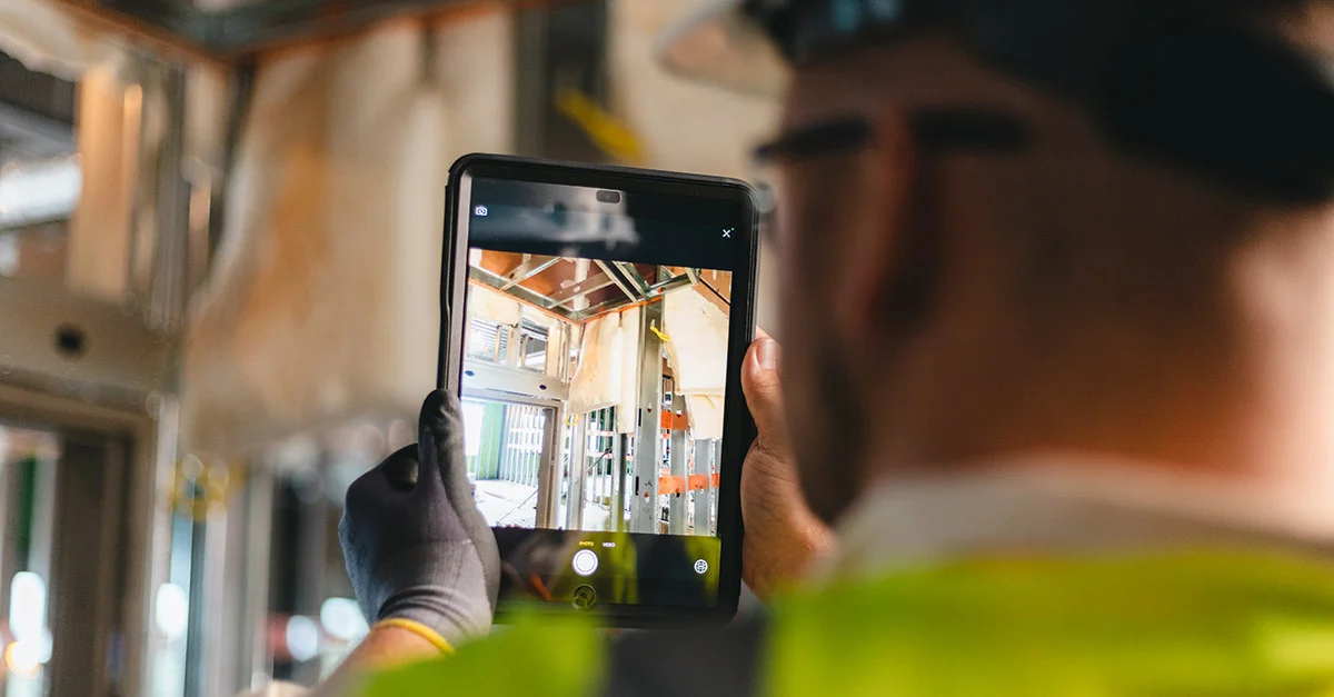 Electrician using mobile device for job documentation